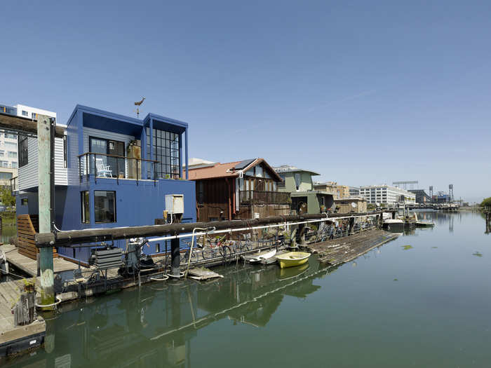 The three-level house sits on a concrete box, with about half of the lower level inside the concrete.