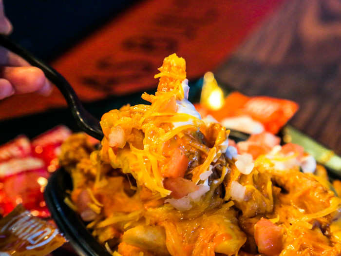 All this queso, melted cheese, and sour cream mixed in with crispy-soft Nacho Fries and tangy, spicy buffalo chicken — it