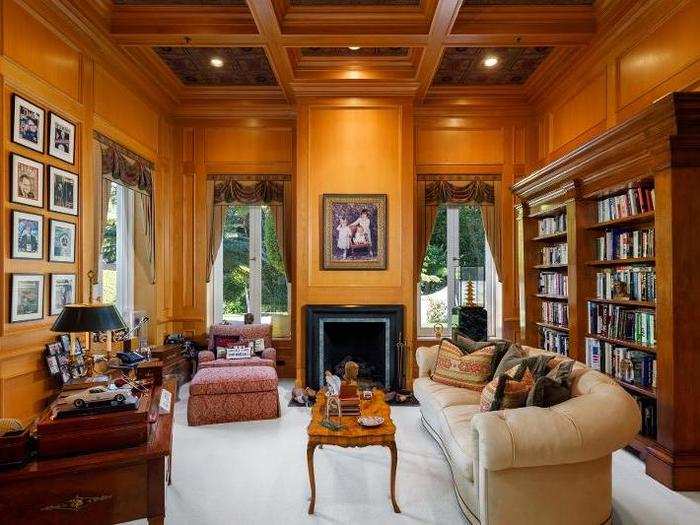 There is a library adorned with wooden walls and a coffered ceiling.