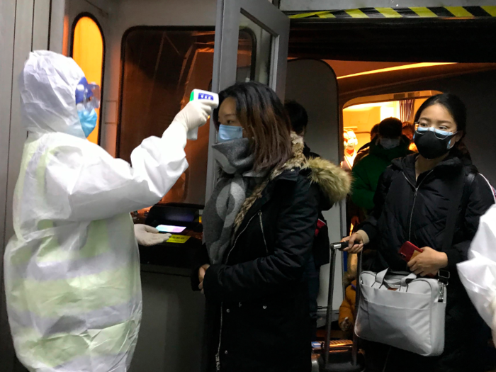 Medics wearing Level D Hazmat suits were seen scanning passengers arriving from Wuhan on January 22.