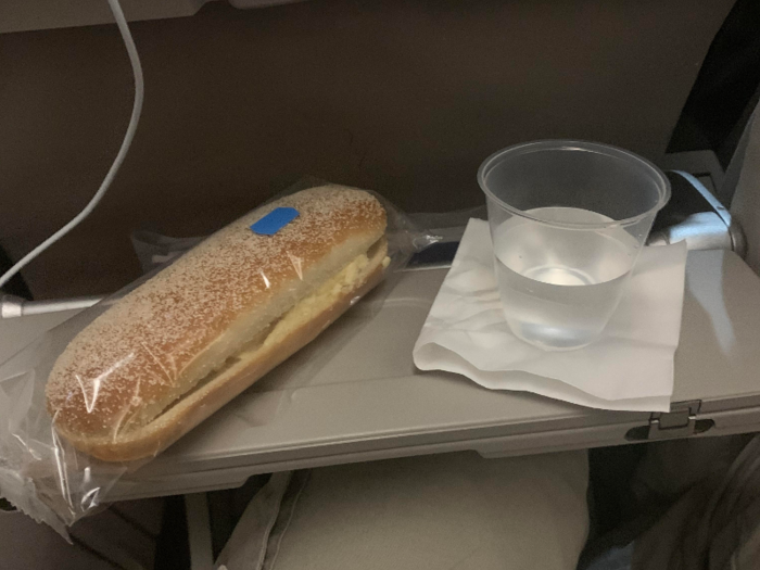 Halfway through the flight, flight attendants handed out cheese-and-egg sandwiches and drinks. I opted for a water.