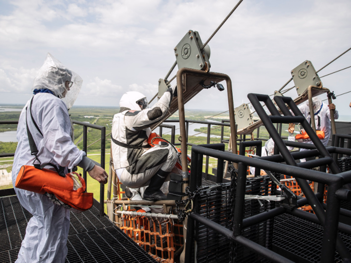 That emergency escape requires the astronauts to load into baskets on a zipline-like wire. Once they zip to the ground, an armored vehicle picks them up.