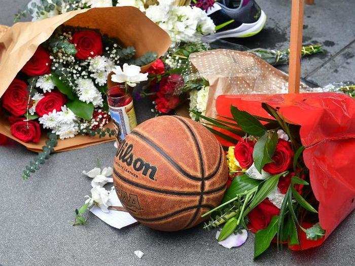 Fans left flowers, basketballs, and sneakers in memory of Bryant.