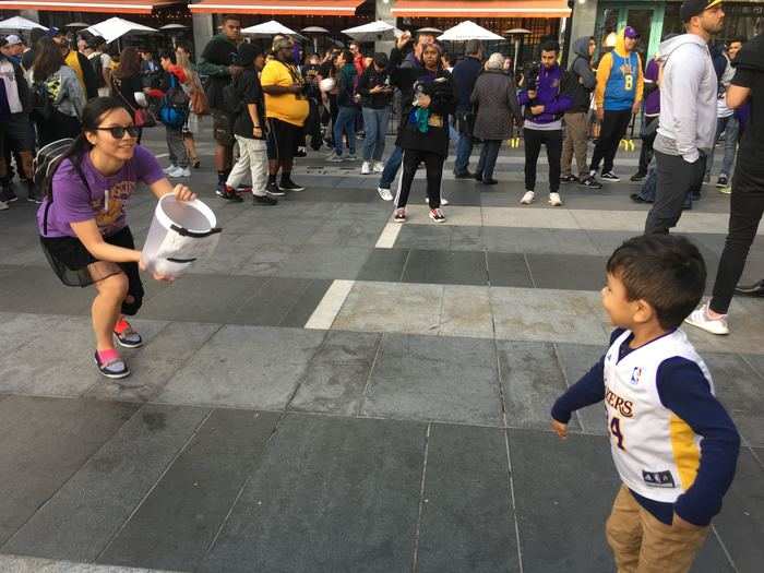 Lakers fan Christy Rusk brought a game for kids and adults alike could shoot paper into the trash can to honor Bryant.