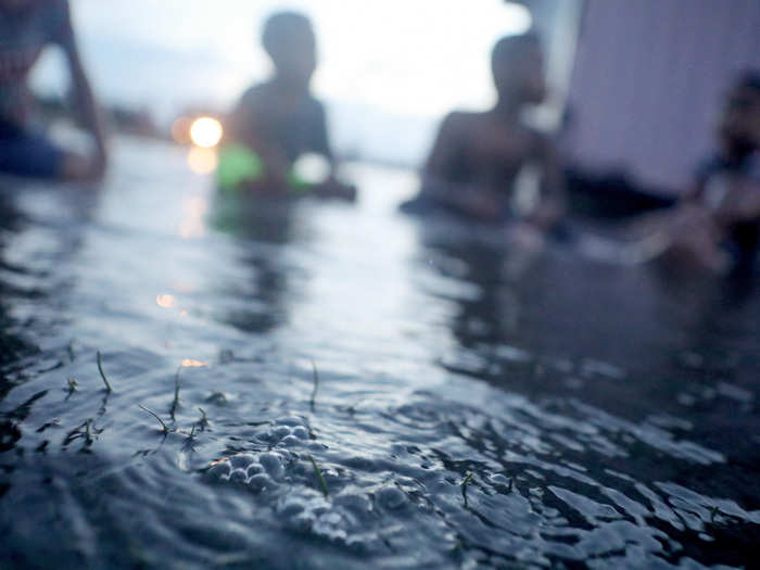 Bubbles percolate from the ground in floodwaters during high tides. A common local saying is, "Tuvalu is sinking."