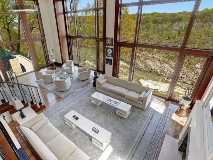 Inside, a two-story living room has river views.