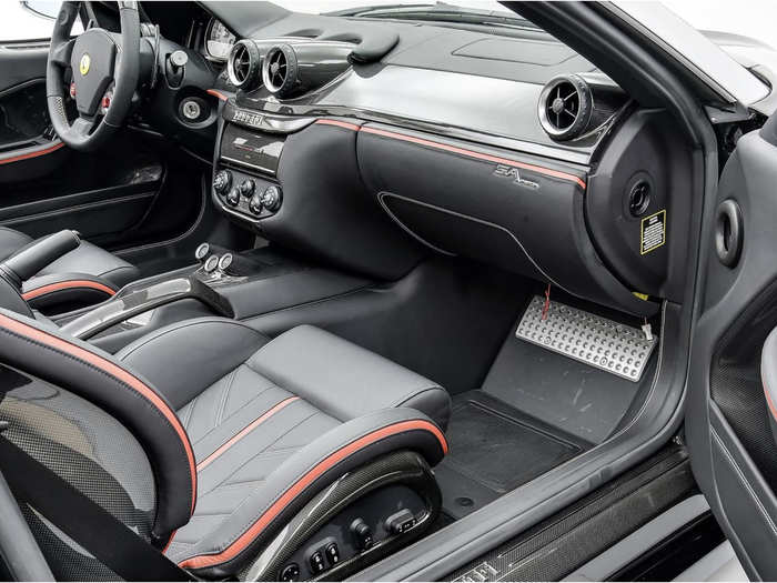 The Ferrari is equipped with a V12 engine and the auction comes with many original parts, including seat and steering wheel covers, factory radio, and a leather cover for the roof.