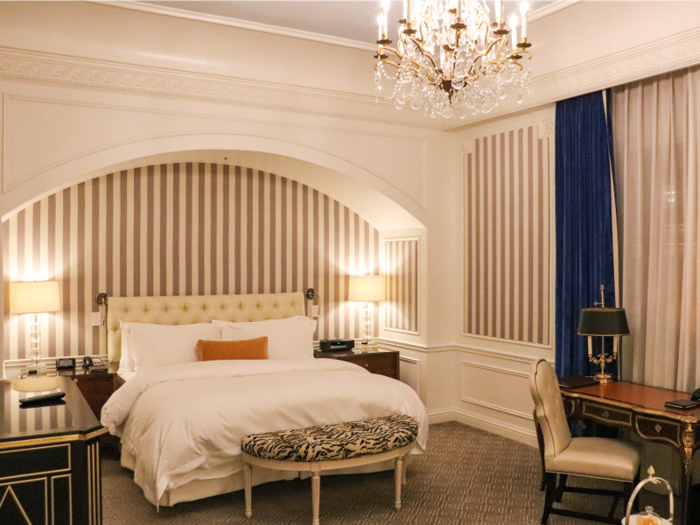 The room itself was decorated in a lavish, classical style, with neutral beige and gold tones and navy blue accents.