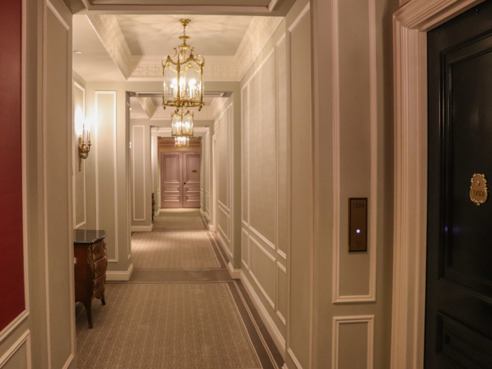 The 12th floor hallway was painted in muted shades of pink with gilded light fixtures.