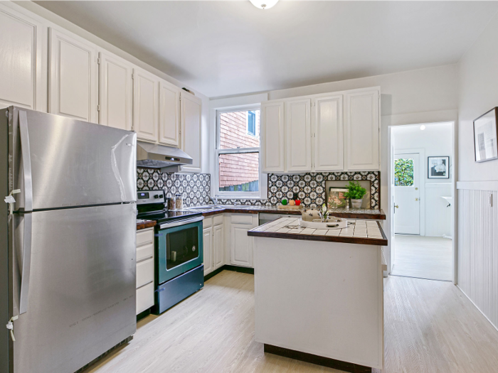 The kitchen has a brand-new stove, stove hood, and refrigerator.