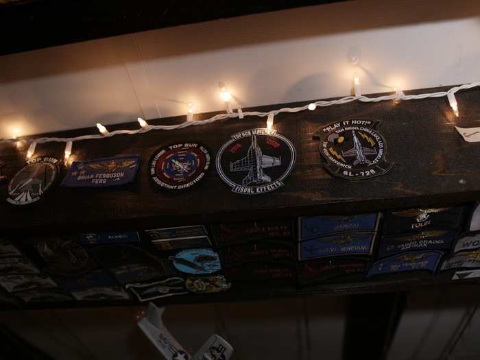 Patches from the production of "Top Gun: Maverick" adorn the bar.