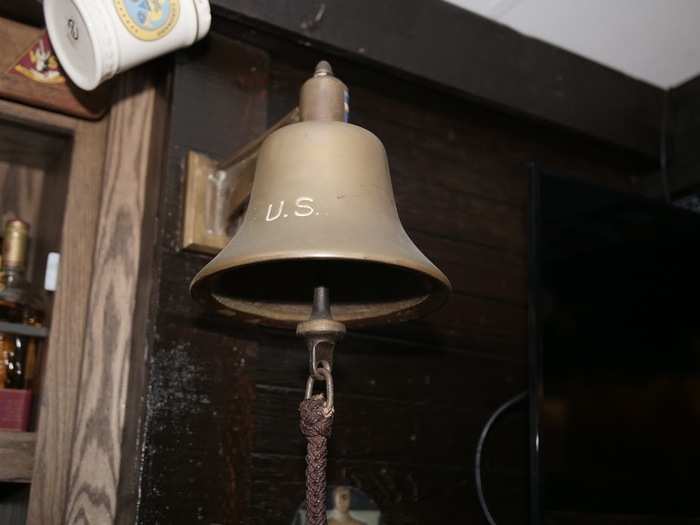 When an errant patron breaks the rules, the bartender rings this bell to signify the infraction, and indicate that he or she owes the bar "a round of cheer."