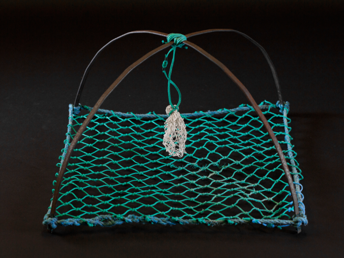 A handmade crab catcher gives another clue to the newly aquatic environment.