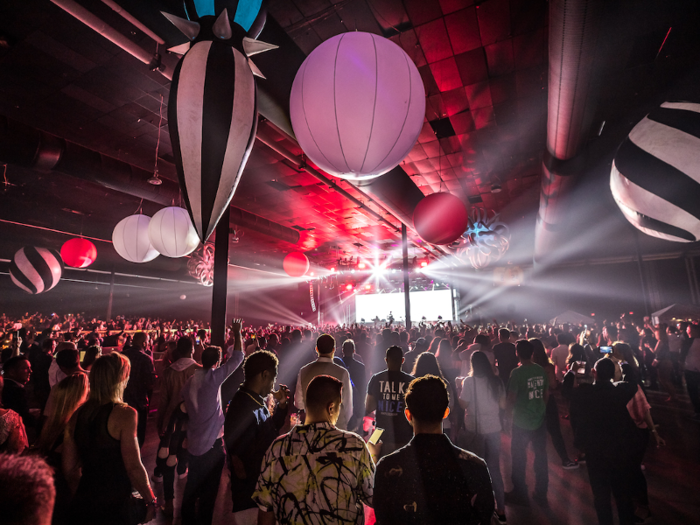 The inside space was massive and already packed with people. Giant balloon-like decorations hung from the ceiling.