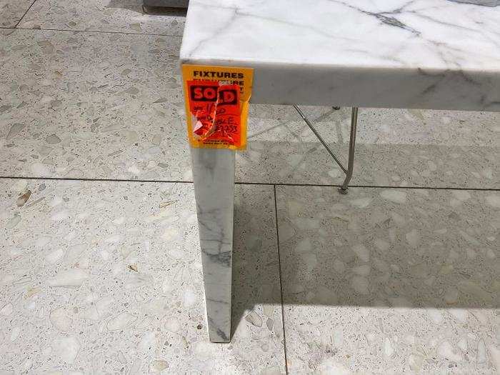 Meanwhile, stickers were affixed to various fixtures around the store to indicate they had been sold, like this marble table ...