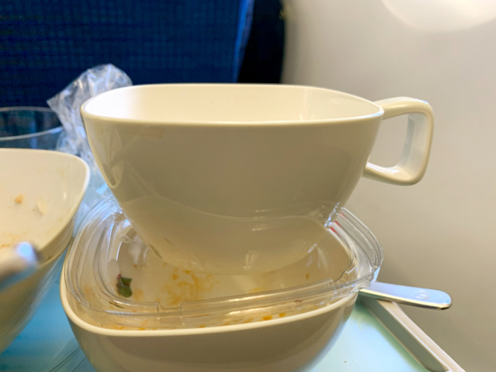 After the meal, flight attendants came around offering everyone tea. I had — foolishly — asked for tea to accompany my meal and had been denied, so was excited to finally get a cup. (Other passengers ordered wine or soda with their meals, but I stuck with water.)