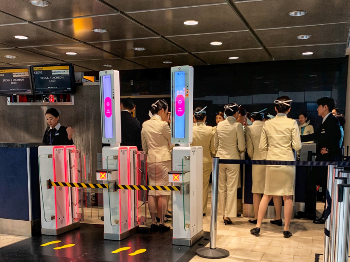 A crowd of more than a dozen flight attendants clustered at the gate as passengers waited to begin boarding.