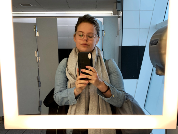 I killed some time by taking selfies in the shockingly well-lit airport bathroom, planning to document my unraveling on the 14-hour flight.