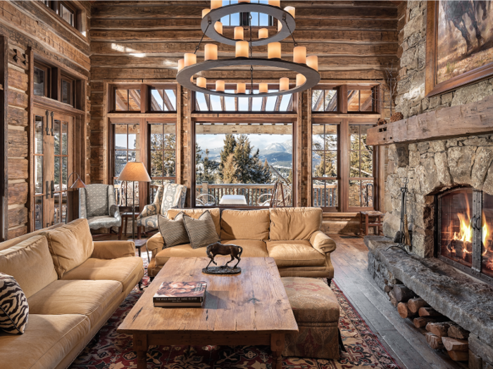 The home features high ceilings, custom stonework, and reclaimed timber.