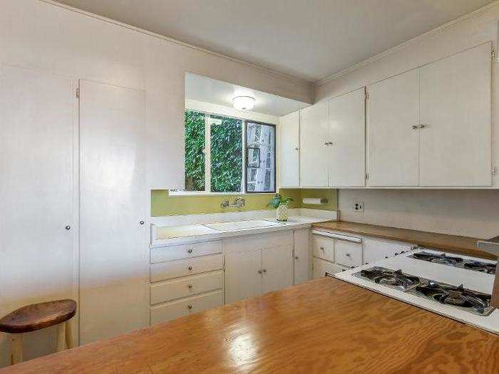 Next door, the kitchen is simple but sufficient with plenty of storage.