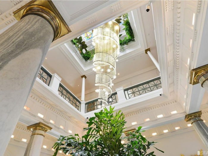 A beautiful chandelier hangs in a three-story atrium.