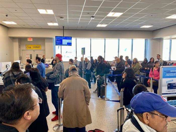 As we lined up to board, I checked the United app and noticed that our plane had been switched to one with the old business class cabin. Our seating assignments had not reverted to what we originally had, so we ended up swapping seats with other people — I noticed a lot of that going on as families tried to get back together.