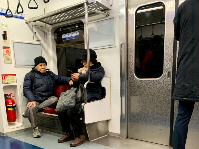 The corner section with red seats is reserved for seniors and handicapped people.