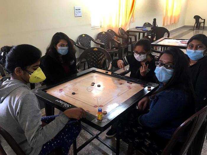 Indian nationals are playing games inside a quarantine facility in New Delhi.