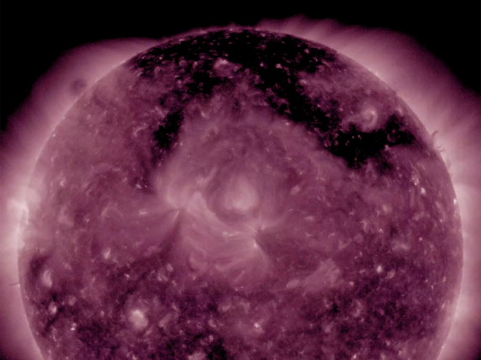 "These coronal holes are enormous at the top of the poles. And we just see the sort of edges of them, or the bits that are kind of creeping down onto the main disk," Pacros said.