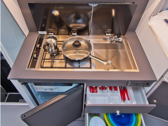 There’s also a cutlery drawer, storage racks, and cupboards that can store utensils.