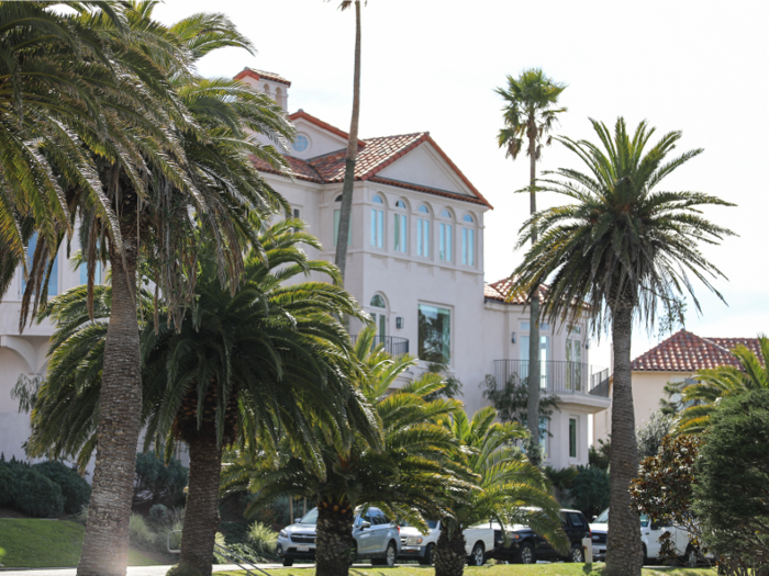 Palm trees, Spanish tile roofing, and red-bricked porches are common sights along the road, and throughout the neighborhood.