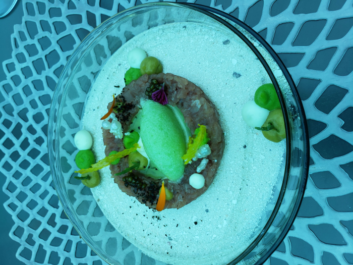 And now for the food itself: Tuna tartare with wakame, wasabi sorbet, and avocado puree was the first dish on the menu. It was served in a clear plate over another clear plate full of sand, a fun way to add depth and design.