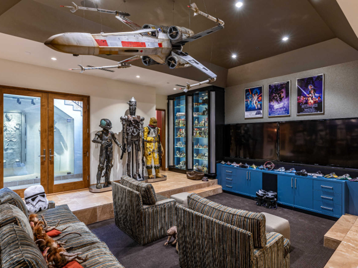 In the lounge area of the basement, a model of an X-Wing fighter hangs from the ceiling.