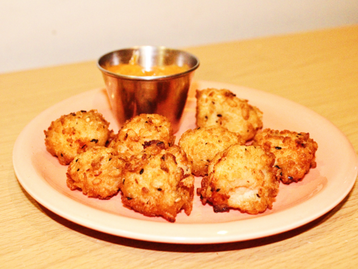 The crispy salmon bites cook in the oven and come with a dipping sauce similar to a spicy mayonnaise or aioli called "Dynamite Sauce."