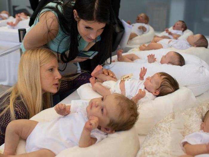 "Judges are looking at reborn dolls during the Valencia doll show" by Didier Bizet