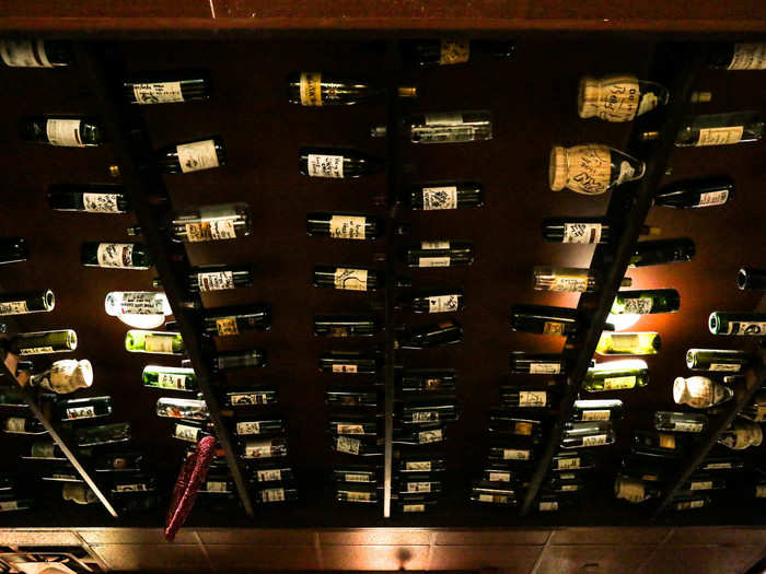 The ceiling was covered with empty wine bottles, all over which previous guests had scribbled messages.