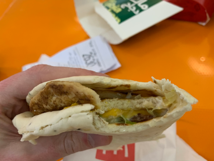 It consisted of Arabic bread (khubz) filled with a chicken patty, cheese, onions, tomatoes, and a sprinkling of iceberg lettuce. It was delicious, a perfect balance of textures.