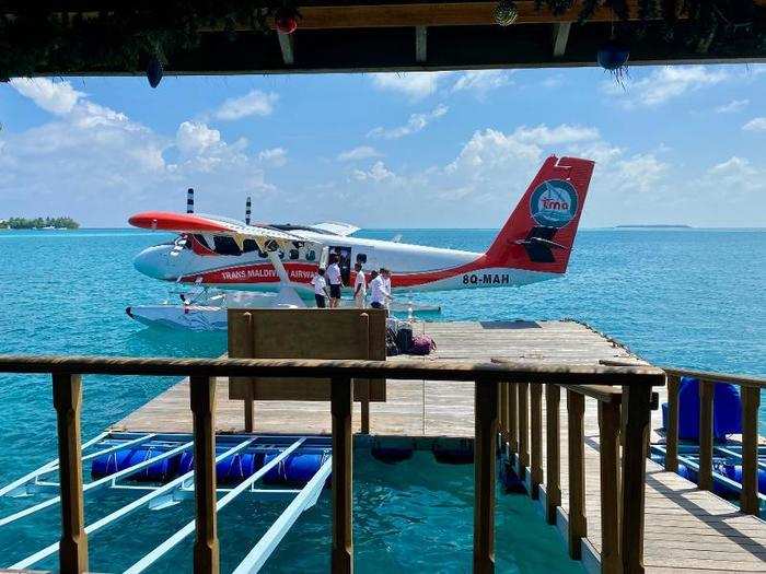 The plane docked, resort employees helped the flight attendant load luggage ...