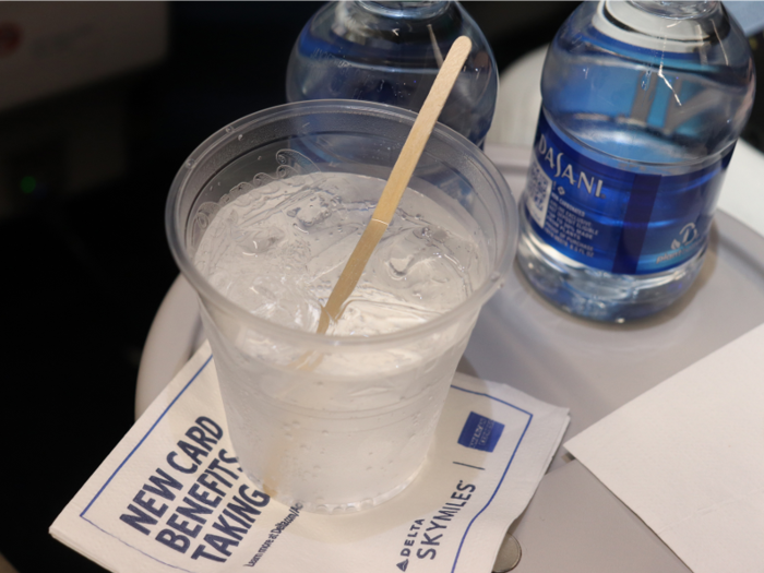 After most passengers were boarded, the dedicated first-class flight attendant came around to take orders for pre-departure drinks. They were served promptly in plastic cups — we wouldn