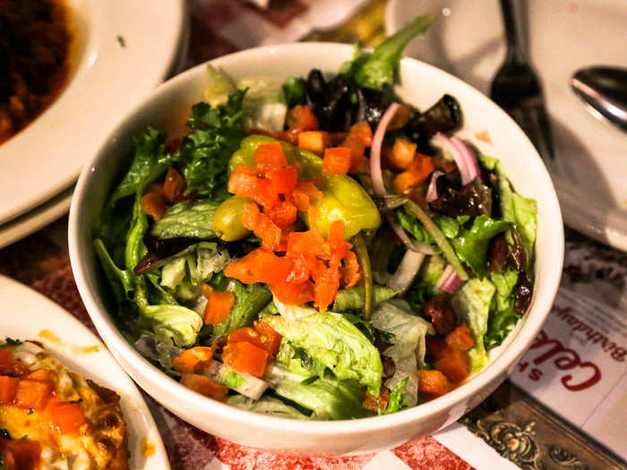 Our green salad also contained red tomatoes, purple onions, and black olives.