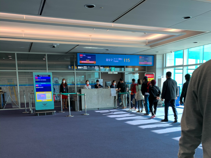 I did not hear the call to line up to board the flight. However, seemingly out of nowhere, everyone started forming an orderly line, so I joined the queue.