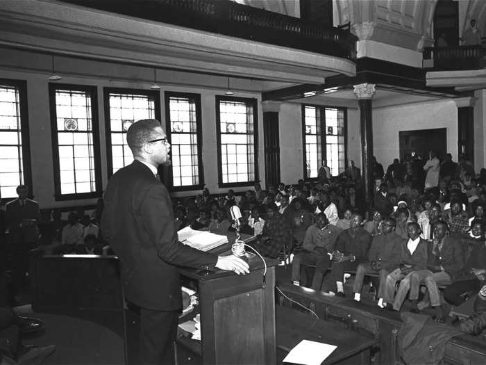 Despite heavy surveillance by law enforcement, Malcolm X continued his rallies. He traveled overseas and spoke at universities. Compared to his early years, he was less aggressive. He was complimentary about King and said that not all white people were devils.