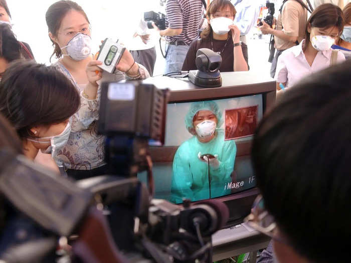 Quarantines popped up in other countries. Here, a nurse talks to her relatives through a webcam in Taiwan in late April. Taiwan was the third worst hit country, with 83 deaths.