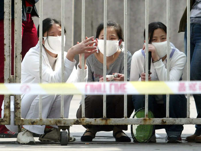 Quarantines became a staple. In Beijing, crime-scene tape was wrapped around an entire block, keeping 2,000 health employees contained and cut off.