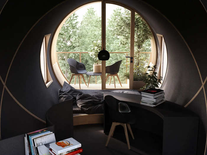 The dark interior orients residents to the large rounded glass windows, which let in light and create a cave-like feel.