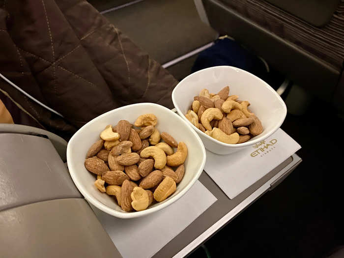 Eventually, we were cleared to taxi and takeoff. A few minutes after we were airborne, the flight attendants came by with dishes of mixed nuts.