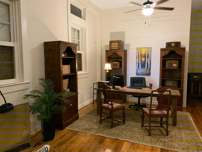 Another one of the front doors opens up into an office space, while the final front door opens up into a storage room.