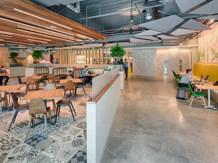 The office is partially open, but wooden partitions and glass walls break up the space and allow for private conversations.