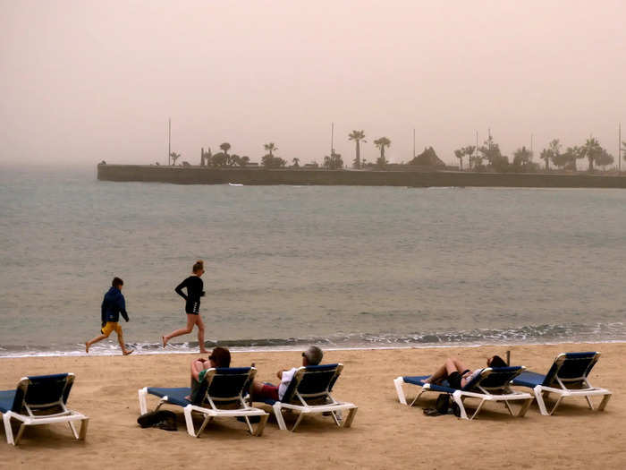 In winter, people visit for the warmth and sunshine. But over the weekend, those lying on beaches had to watch the horizon disappear in a dusty haze.