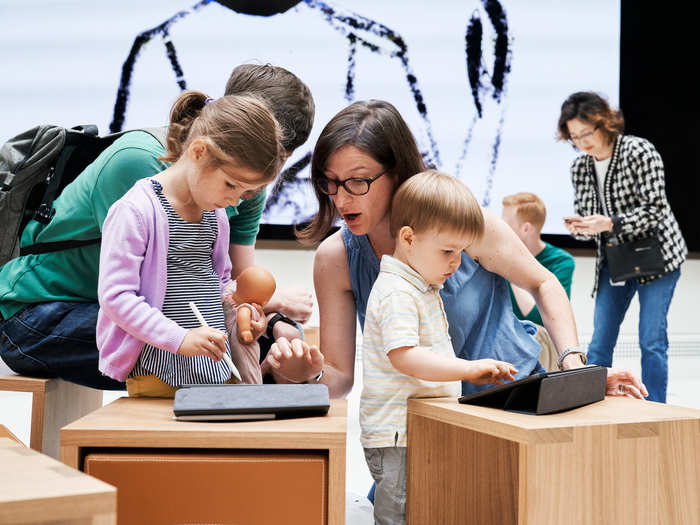 These days, Apple stores have something called "The Forum," which is a dedicated space for classes in subjects like coding or photography. The spaces feature a 35-foot-wide screen and stools designed by Ive